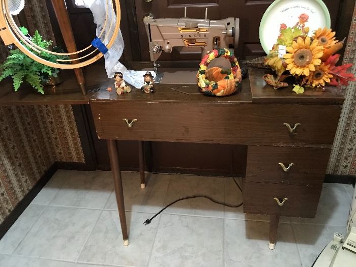 vintage Singer sewing machine in cabinet with stool