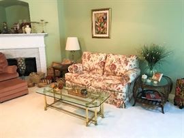 Floral loveseat, Brass and Glass Coffee Table,  Rattan and Glass Table