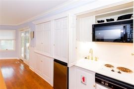 Wet bar/mini kitchen; custom cabinetry throughout