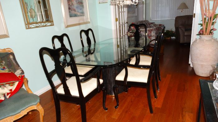 MODERN GREEN ITALIAN TRAVERTINE MARBLE BASE GLASS TOP DINING TABLE WITH SIX EBONY CHAIRS. TWO ARMED CHAIRS AND FOUR SIDE CHAIRS. LARGE TERRACOTTA POTTERY DECOR FLOOR VASE.