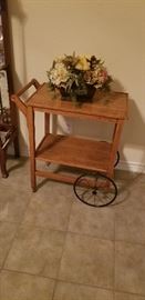 Antique tea cart with metal wheels