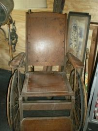 Vintage wooden and metal wheel chair.  In good condition with repair needed on the metal rim of one wheel.