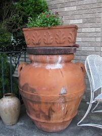 one of pair of large oversized terra cotta urns ,