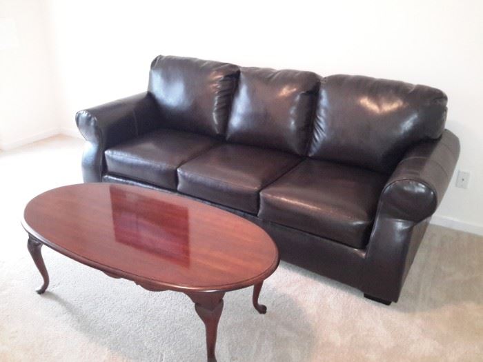 Leather look sofa / oval coffee table 