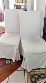 2 white dining chairs