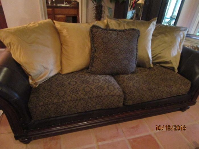 Sofa - Brown leather/fabric cover.  Brown with green and light color cushions 