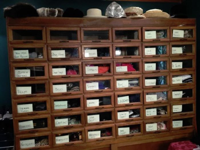 42 GLASS FRONT DRAWER CABINET WITH STORAGE.   Filled with stockings, bra's, body shapers, jewelry, umbrellas, gloves.  Great Storage piece. 