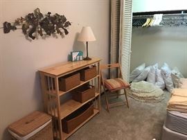 Bedroom view with metal sculpture on wall