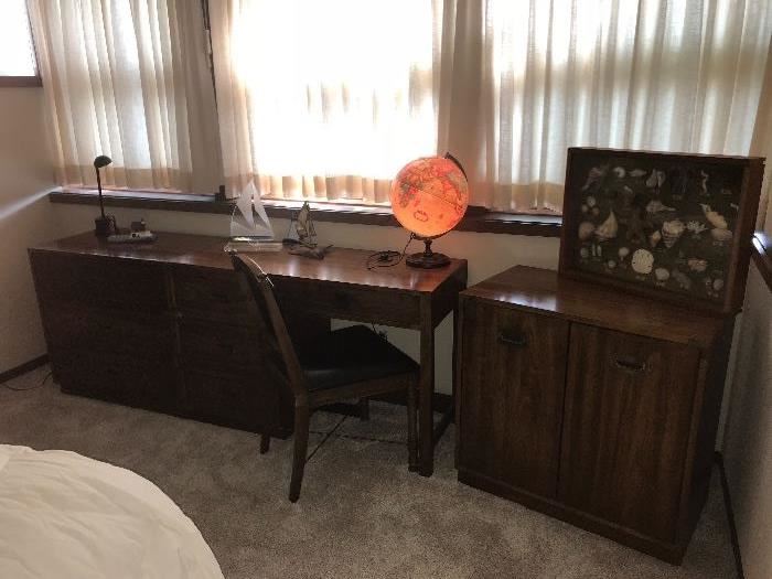 Campaign style Desk and chair with lighted globe displayed, next to coordinated cabinet