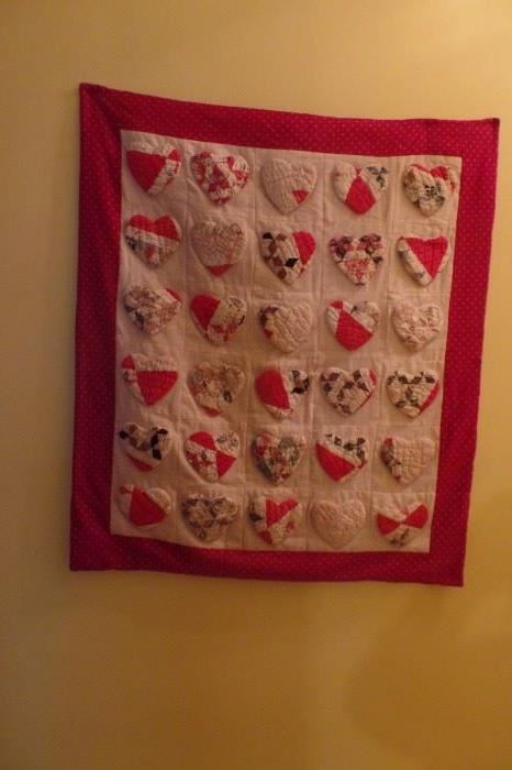 Handmade vintage hearts on handmade quilt