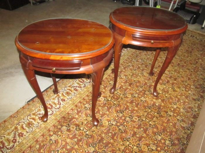 Pair of round cherry tables with glass tops