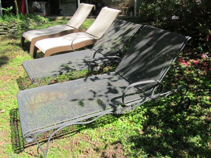 pair of wrought iron chaise lounges
