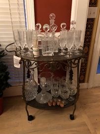Metal Beverage Cart on wheels.  Lots of crystal decanters, Ice buckets, and glasses