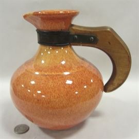 Mid-century pottery pitcher with wood handle, orange mottled "sponge" glaze