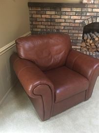 This brown leather chair is in like new condition - the perfect place to curl up with a good book!