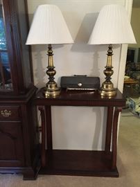 Side table and brass lamps.