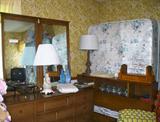 Bassett bookcase headboard bedroom set with large dresser and mirror and bedding.