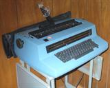 Great IBM BLUE SELECTRIC III TYPEWRITER AND STAND. THE FLASH MADE IT LOOK LIGHT AND DARK BUT IT'S JUST THE FLASH