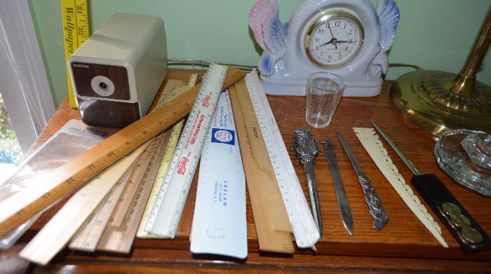 vintage rulers with various logos; letter openers; electric pencil sharpener