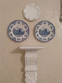 There's a collection of blue/white plates on the wall.