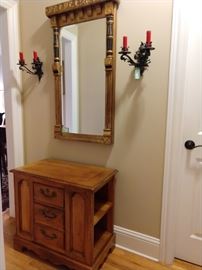 Vintage Thomasville chest, with antique gilded/ebonized wood wall mirror, flanked by a pair of German wrought iron 2-light wall sconces.