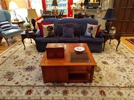 Lovely hand woven Oushak design rug, measures 11' 4" x 14' 3", Ethan Allen wood/beveled glass coffee table, newly upholstered sofa, pair of vintage mahogany Ethan Allen end tables, with unmatched pair of table lamps.