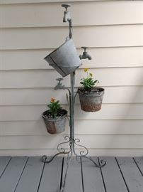 A drippy galvanized steel planter, with orange violas, doing what they do best - bloom their heads off!
