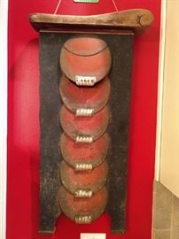 There's a pair of these wonderful Art Deco cast iron theater seat ends. Right beneath the top circle, there's a hole for the light to shine the path to your seat, in the dark.