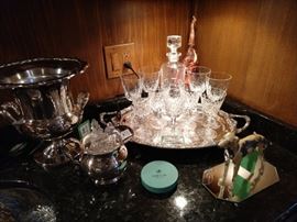 A little bar vignete to whet your appetite! A small collection of Waterford Lismore, on a silverplated tray, a chippy spelter greyhound to guard your favorite drink recipies, Rogers silverplated champagne bucket, w/liner and waaay in the back, a vintage, leather covered elephant liquor bottle - trunk up, so you know what that means!