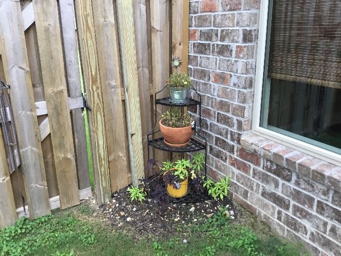 Small wrought iron shelf unit and plants