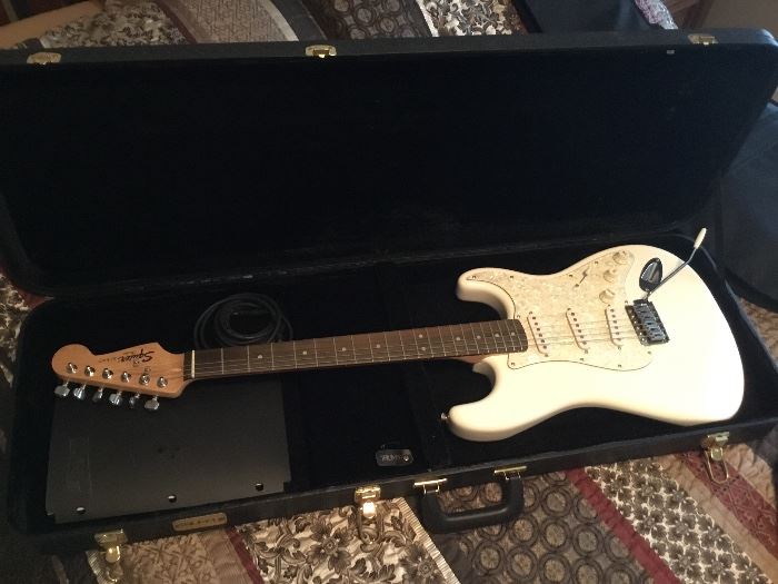Fender Squier Strat white electric guitar with hard case.