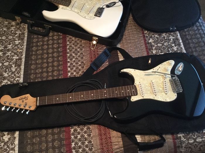 Black and white Fender Squier Strat in soft Fender carry case