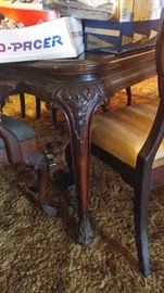 Antique dining table has a few chairs that need love