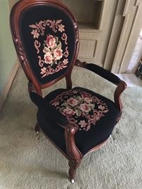 Lots of carved wood chairs with hand embroidered upholstery.