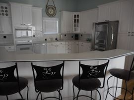 Crisp & clean white kitchen; stainless steel fridge with French doors