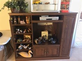 Duck Sculptures & Decoys fill the shelves of this Display, Storage & Entertainment Unit