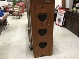 Heart cut outs in small wooden cabinet