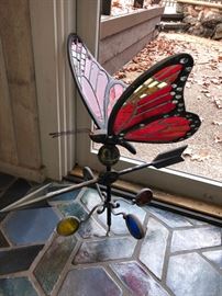 Stained glass weather vane with butterfly....