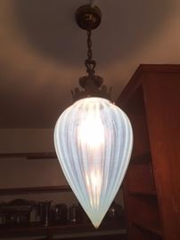Rare antique glass ceiling fixture with vertically striated, teardrop-shaped globe in a pale blue-white color resembling milk glass.  In flawless condition. since the 1970s it has been hanging in the back pantry on the first floor. Shown privately by request only.  