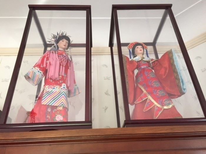 Modern Chinese dolls in opera (?) costumes, standing in beautiful wood-rimmed glass vitrines.