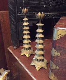 Pair of small Chinese brass candlesticks in the form of 7-story pagodas. In the dining room.