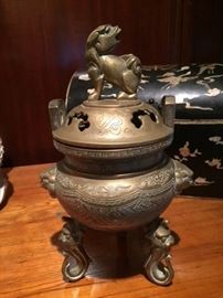 Small, antique Chinese 3-footed brass censor with finial in the shape of a dragon or dragon-like creature. In the dining room.