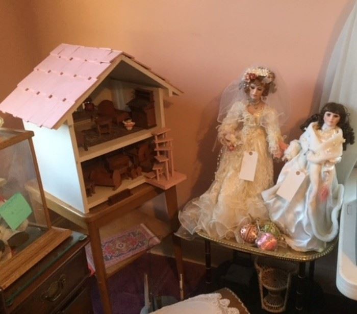 Doll house & dolls in the pink bedroom on the second floor.