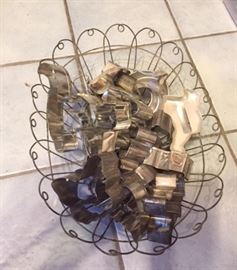 Vintage wire basket with cookie cutters.