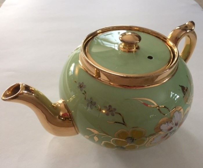 Ceramic tea pot in gilt-edged celadon green.  