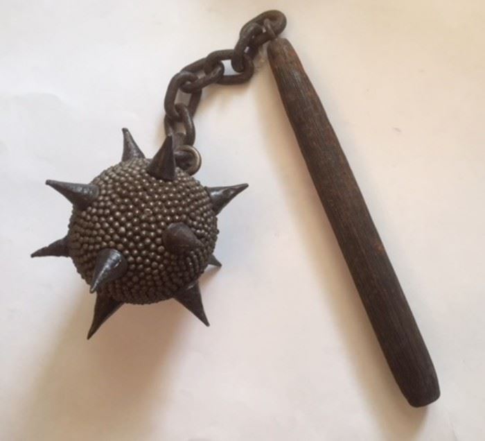 All sorts of things  turn up in the far corners of an old house, including this "Chain Morning Star" or "Spiked Flail," a mace-like weapon comprising a wooden shaft, metal chain, and spherical, pointed metal striking ball.  Judging from the wear on the chain links and on the wood handle, this flail might be rather old.  Not on display at the sale. Please inquire at the front desk if you'd like to see it. We thank Beth T. for helping us to identify identify this weapon...and advising us to sell it to a level-headed person. 