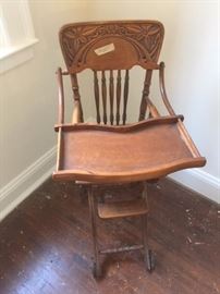 Antique wooden high chair in excellent condition with Art Nouveau-like motifs. In the pink bedroom on the second floor. 