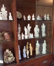 Chinese & Japanese white porcelain figurines, Chinese soapstone carvings, and other beautiful pieces. In the living room. 