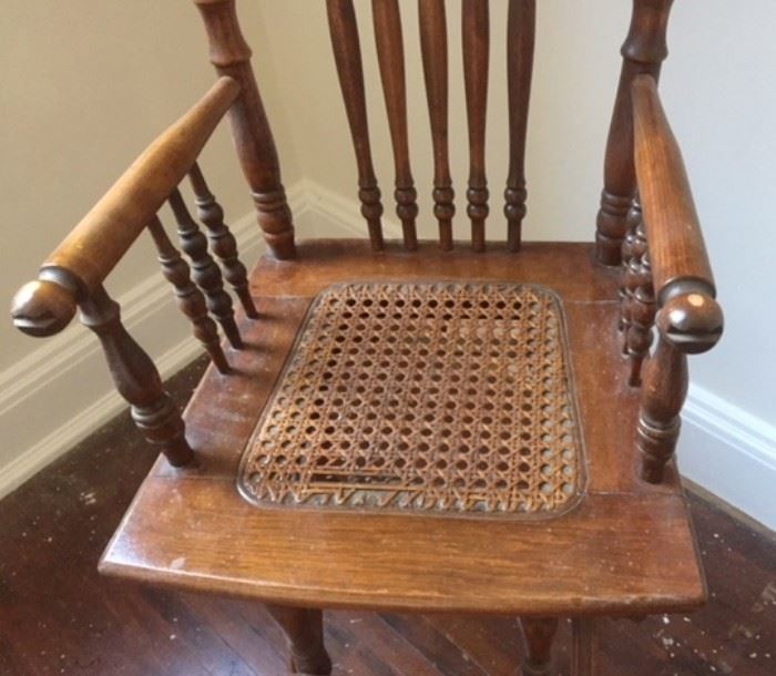 Detail of caning and spindles on antique high chair. 