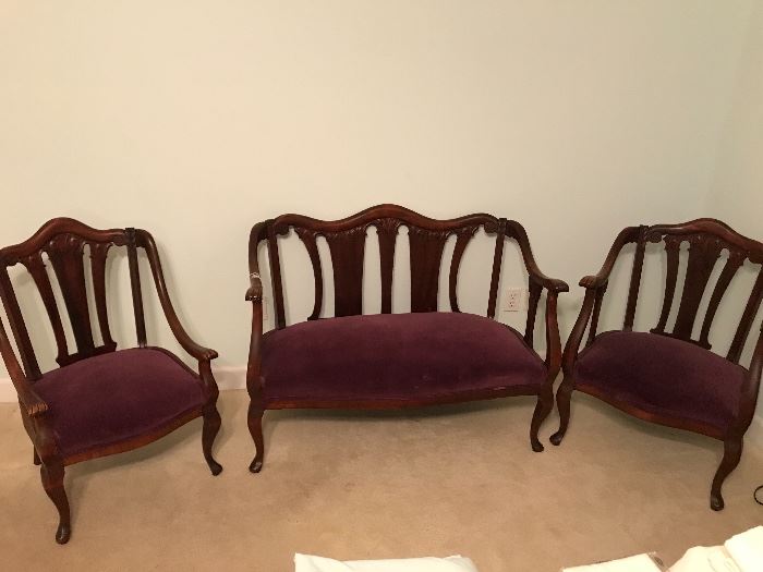 This lovely and delicate French Parlor Set has original finish on aged mahogany wood and a deep plum velvet upholstery.  